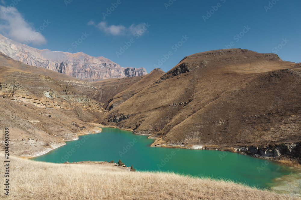Mountain lake in the Caucasus on the background of epic rocks