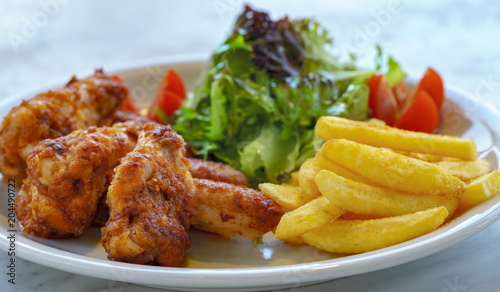 Turkish style chicken wings served with potato fries and salad