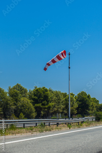 Highway with a red wind indicator between the roads