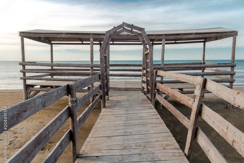 Wooden bridge leading to seaside.