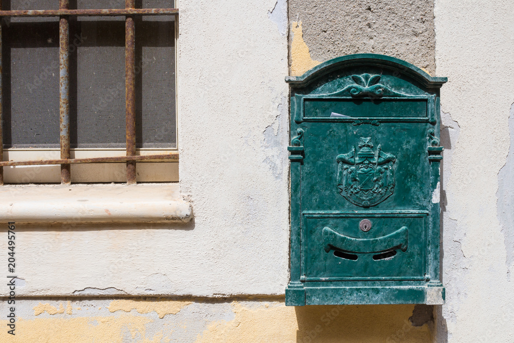 Green old mailbox. Castelsardo, Sardinia, Italy