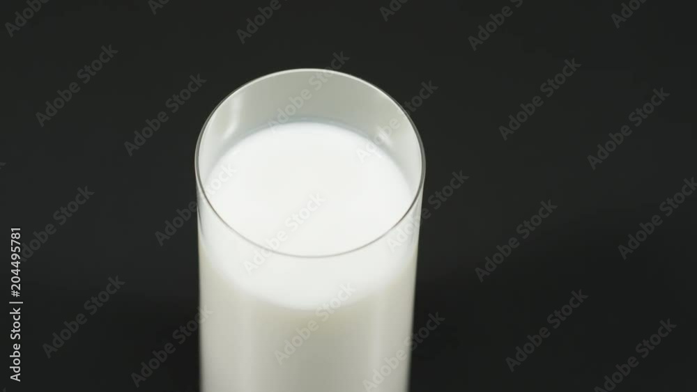 Putting down a filled glass of milk Putting down a filled glass of milk