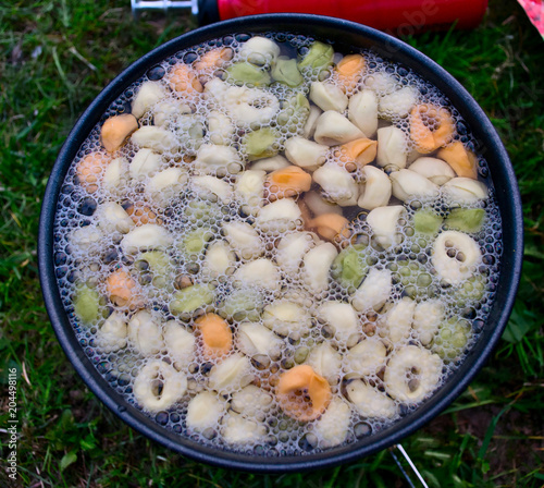 Tortellini in a boiling pot at the campsite