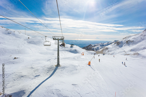 Skilift and slopes in Piancavallo in a sunny winter day, near Mount Tremol and Cima Manera, Friuli Venezia Giulia