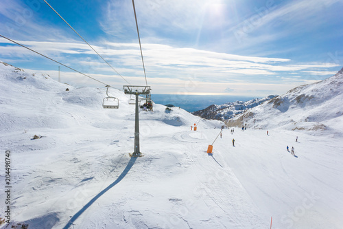 Skilift and slopes in Piancavallo in a sunny winter day, near Mount Tremol and Cima Manera, Friuli Venezia Giulia photo