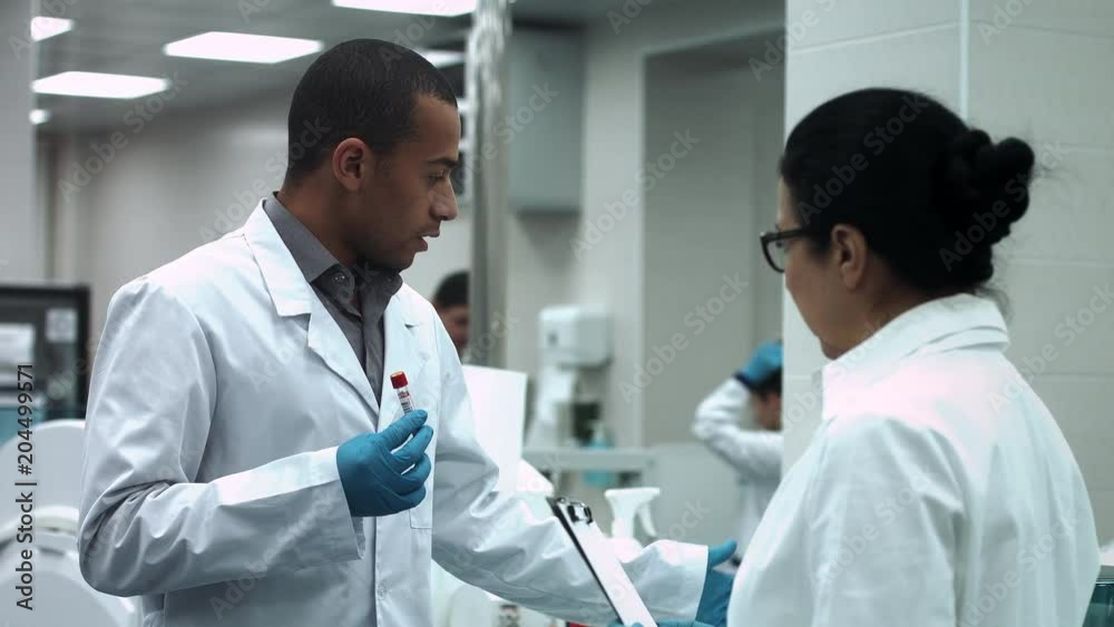Laboratory researchers discuss work at the laboratory Laboratory researchers discuss work at the laboratory