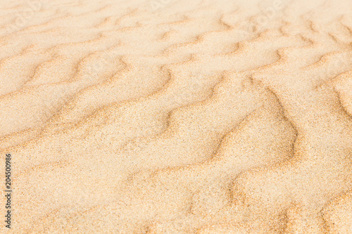 Sand waves texture with diagonal pattern. Sandy beach for background. Perspective view