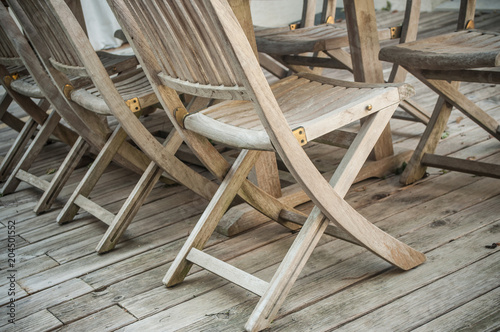 closeup of Teak garden furniture on a wooden terrace in spring