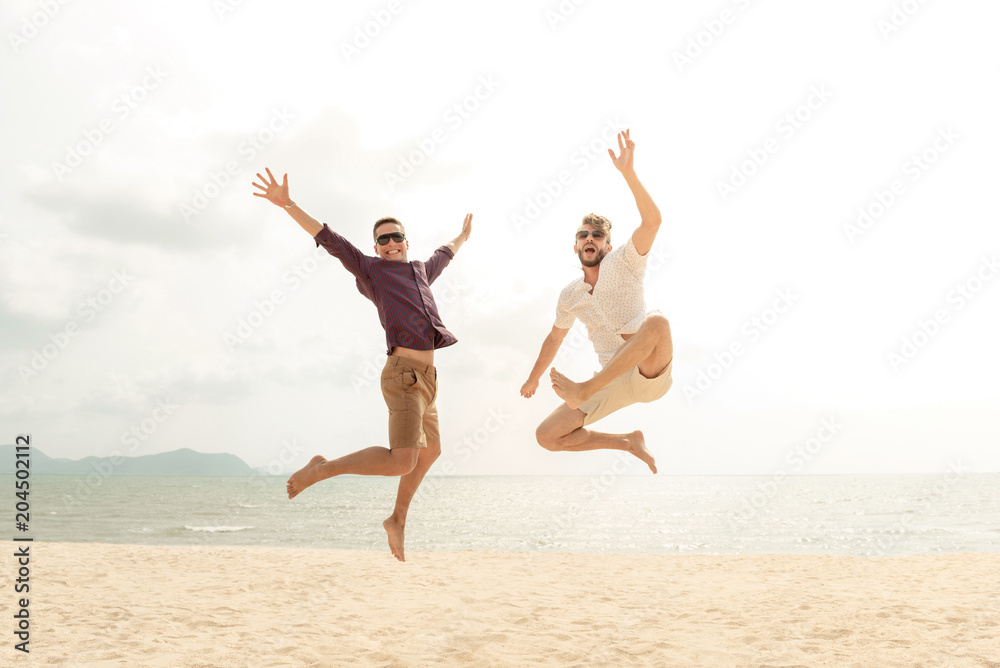 Young energetic happy tourist men jumping at the beach Young energetic happy tourist men jumping at the beach