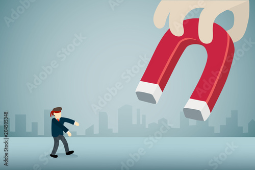 businessman with blindfold walking to big magnet.
