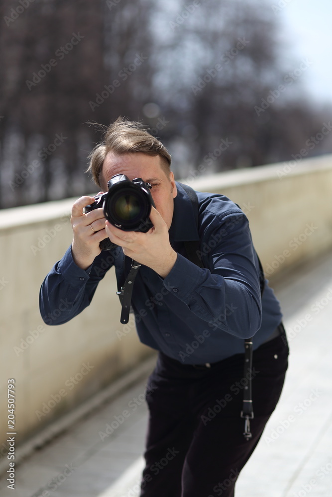 Work of the photographer. A man looks at the camera lens. Journalist. Work of the photographer. A man looks at the camera lens. Journalist.