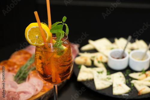 Obraz na płótnie Traditional italian aperitif with proscioutto, mortadella sausage, cheese and aperol spritz drink w salonie
