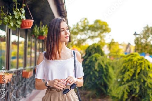 Young beautiful caucasian woman posing outdoor in the city