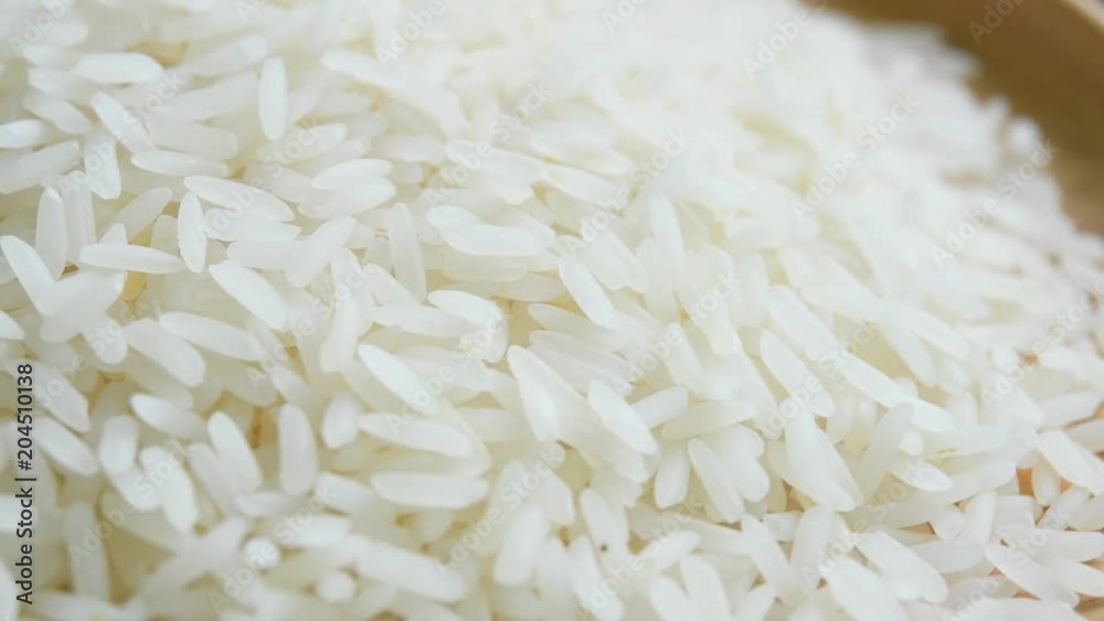 close up of a pile of raw rice. rotating close up of a pile of raw rice. rotating
