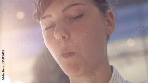 Portrait of a young woman eating food.