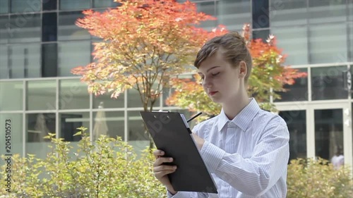 Woman with Clipboard Taking Notes