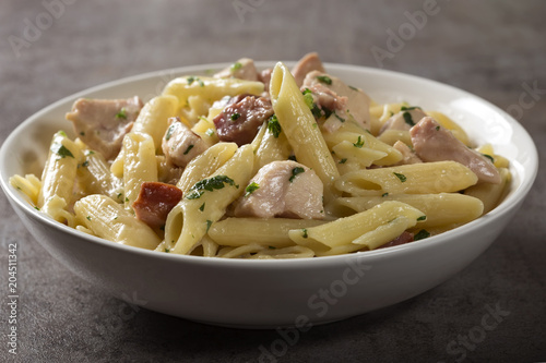 Italian pasta penne with chicken meat and bacon