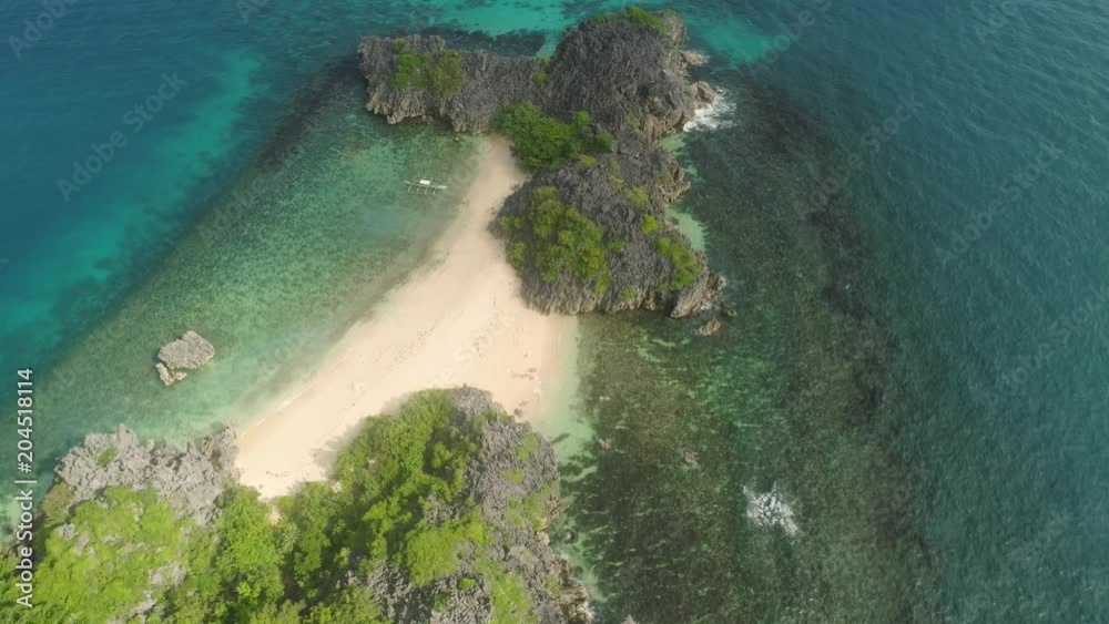 Aerial view island with sand beach and turquoise water in blue lagoon among coral reefs, Caramoan Islands, Philippines. Landscape with sea, tropical beach. Aerial view island with sand beach and turquoise water in blue lagoon among coral reefs, Caramoan Islands, Philippines. Landscape with sea, tropical beach.