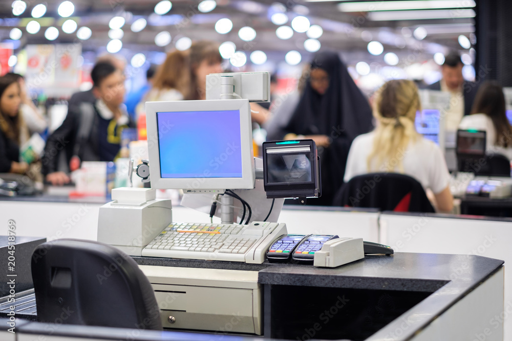 Cash desk terminal with cashiers and customers on blurry background Cash desk terminal with cashiers and customers on blurry background