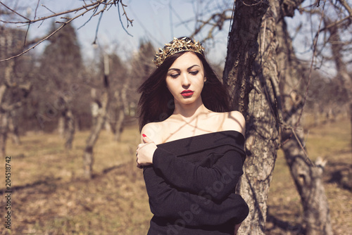 Brunette in a spring apple orchard photo