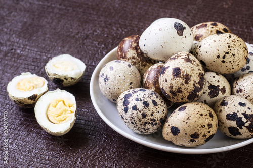 fresh quail eggs on white plate