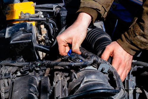 man's hands closeup and car parts, car repair