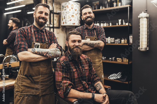 Hipster young good looking man visiting hairstylist and barber in barber shop. photo