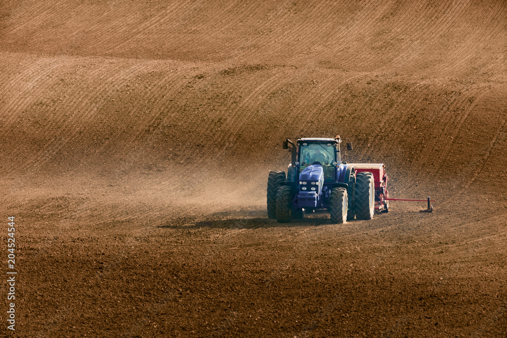 Obraz premium tractor with seed drill on field