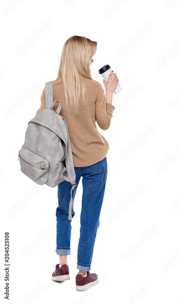 Back view of walking woman with coffee cup and backpack. Back view of walking woman with coffee cup and backpack.