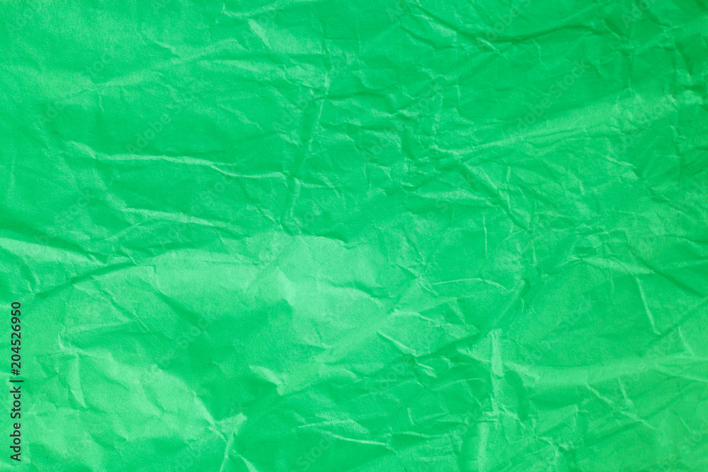 Fototapeta premium Green crumpled paper background.
