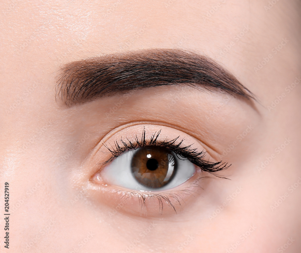 Beautiful woman with perfect eyebrows on light background, closeup Beautiful woman with perfect eyebrows on light background, closeup