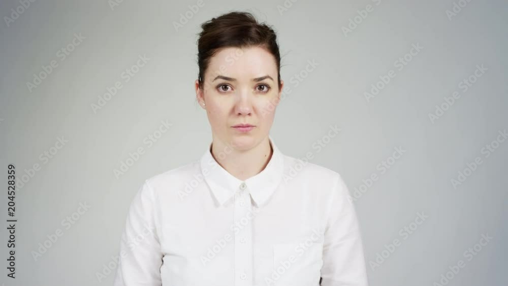 Serious woman starting laughing Serious woman starting laughing