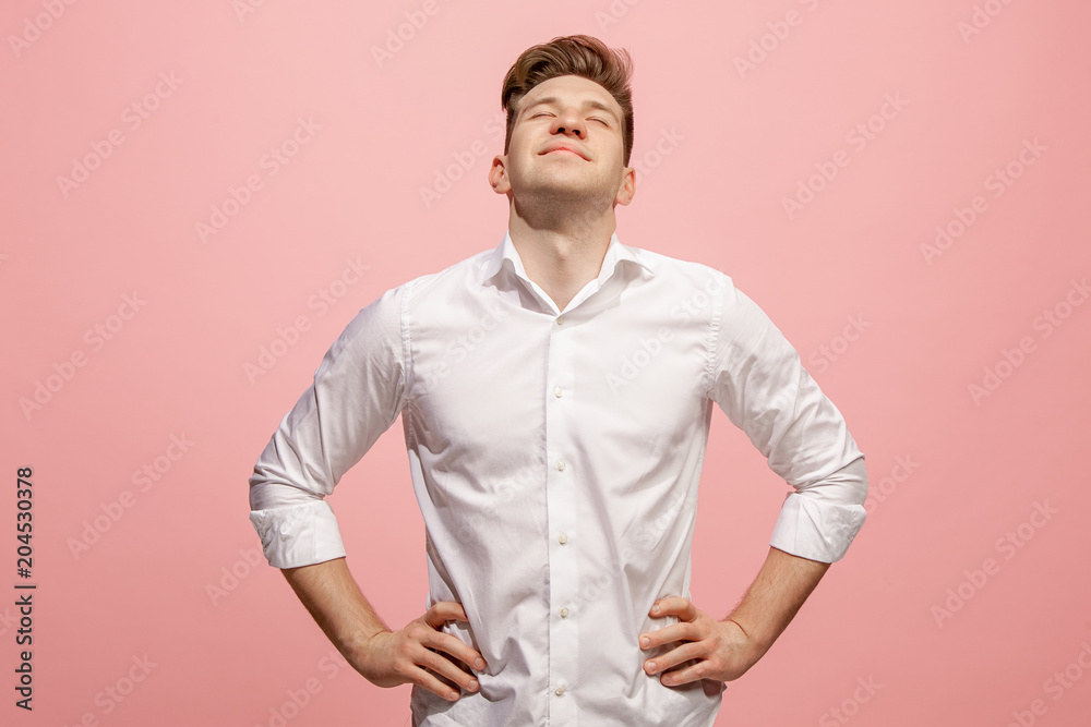 The happy business man standing and smiling against pink background. The happy business man standing and smiling against pink background.