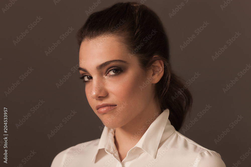 Beautiful woman portrait wearing white blouse and looking at camera Beautiful woman portrait wearing white blouse and looking at camera