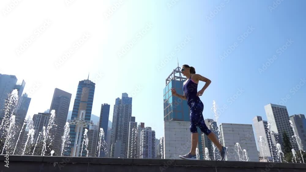 Young, sporty woman jogging in city, super slow motion 240fps
Young, sporty woman jogging in city, super slow motion 240fps