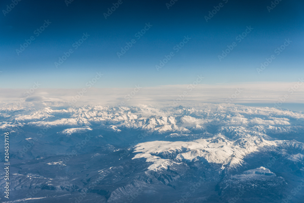 Mountain range in Caucasus mountains with snowy tops.