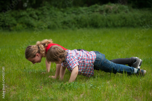 Girl and little boy doing push-ups