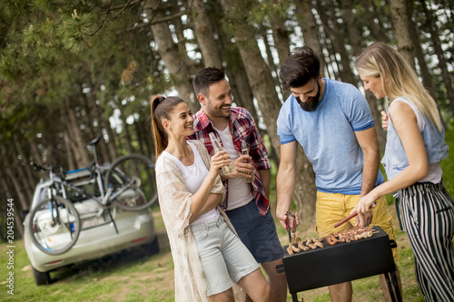 Young people enjoying barbecue party in park