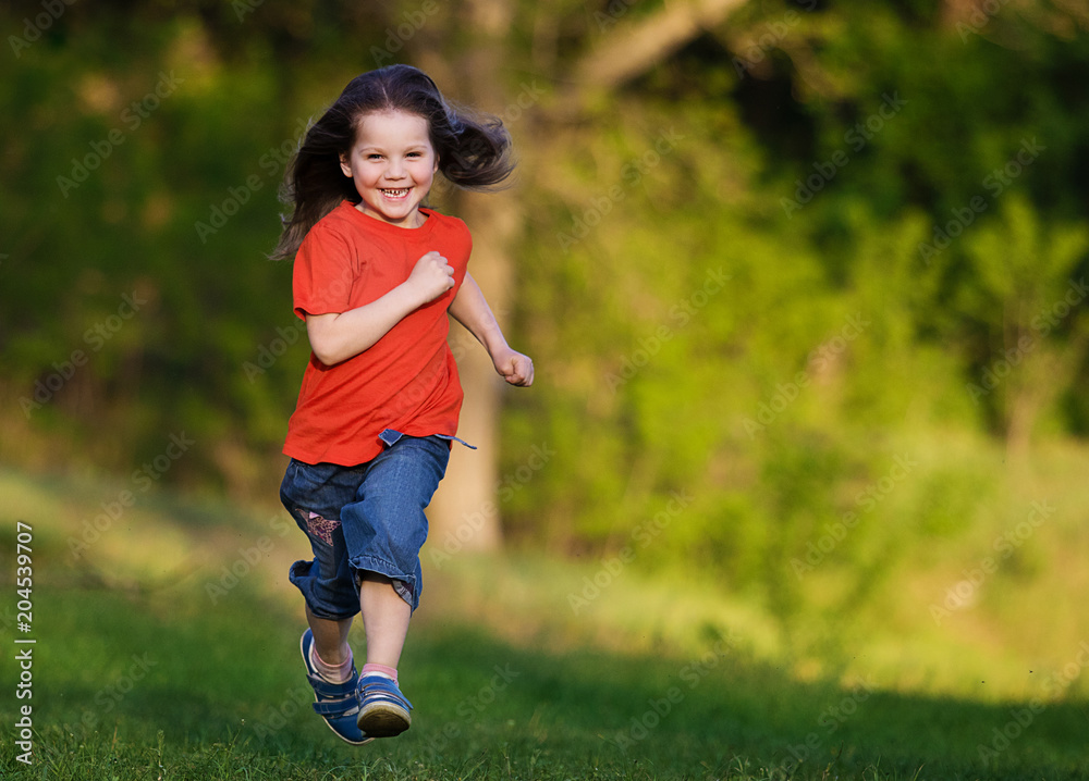 little girl running fast in the park Stock Photo | Adobe Stock