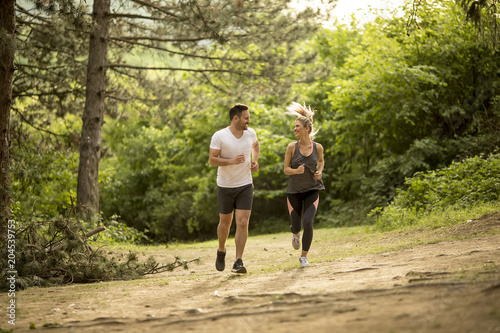 Couple jogging outdoors in ...