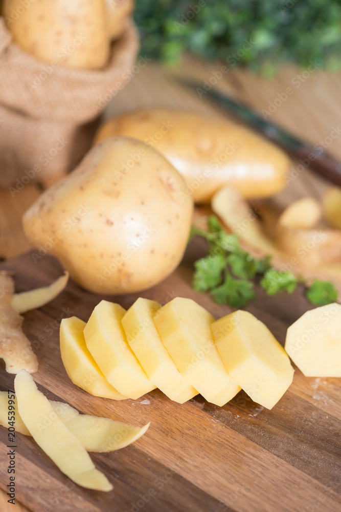 Potatoes on a cutting board sliced into pieces. Potatoes on a cutting board sliced into pieces.