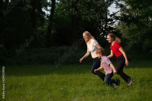 Mother and children running.