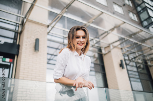 Free Download Young Woman on the balcony enjoying city view - GFXLoad