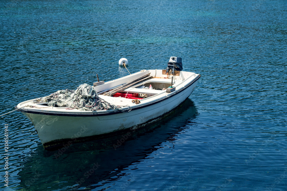 Fishing boat at sea.Boat at beautiful blue water Fishing boat at sea.Boat at beautiful blue water