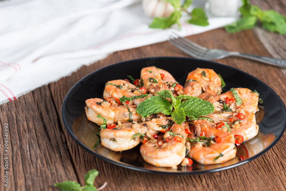 stir-fried Shrimp with pepper and garlic on black plate. stir-fried Shrimp with pepper and garlic on black plate.