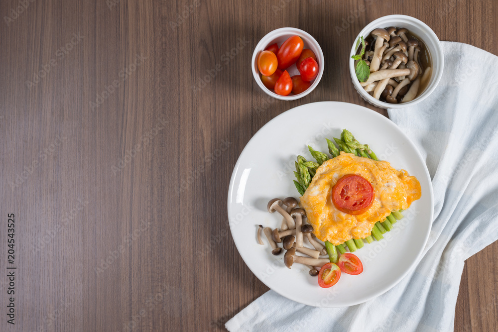 Grilled asparagus with omelette and grill tomato, stir fry shimeji mushroom. Grilled asparagus with omelette and grill tomato, stir fry shimeji mushroom.