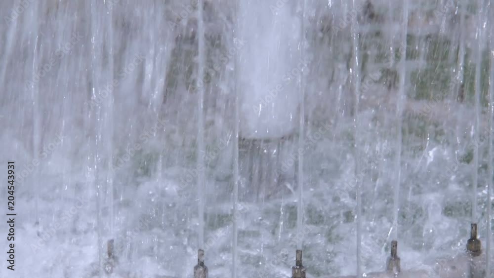 A stream of water from a fountain close up. A stream of water from a fountain close up.