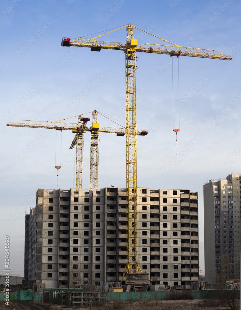 Tower cranes and high-rise building