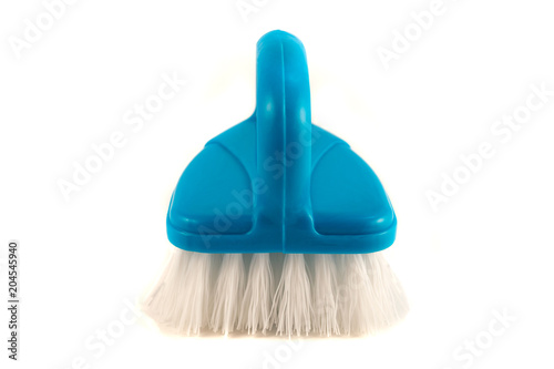Brush for cleaning household surfaces from dirt on a white background.