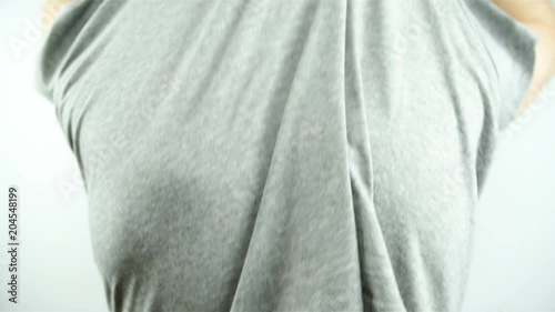 Person undressing shirt showing skin moles 4K